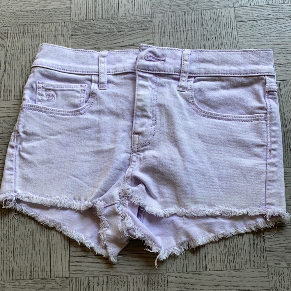 Light purple jean shorts.